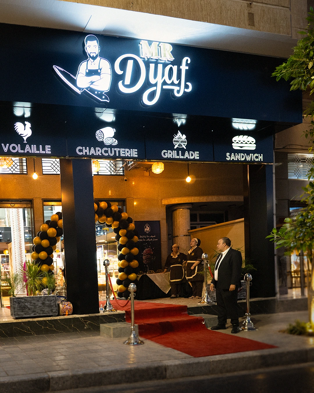 The lit Mr Dyaf storefront at night